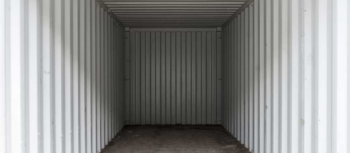 Plywood floors on the interior of a shipping container.