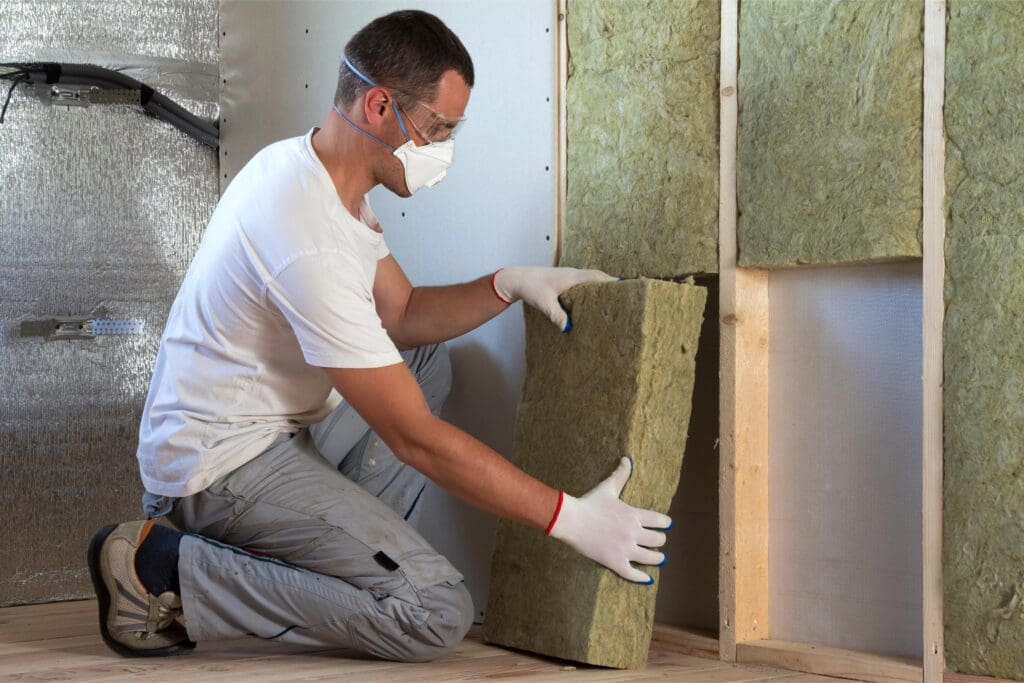 Man installing insulation