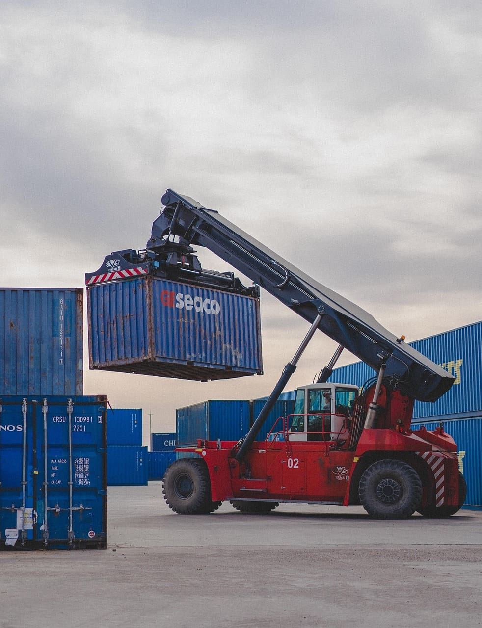 Large crane lifting a shipping container.