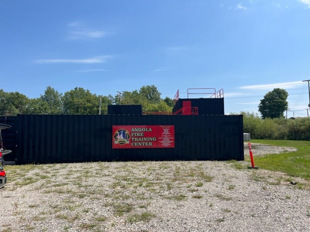 Angola Fire Training Facility – modern fire training building with used 40 ft shipping containers painted black.
