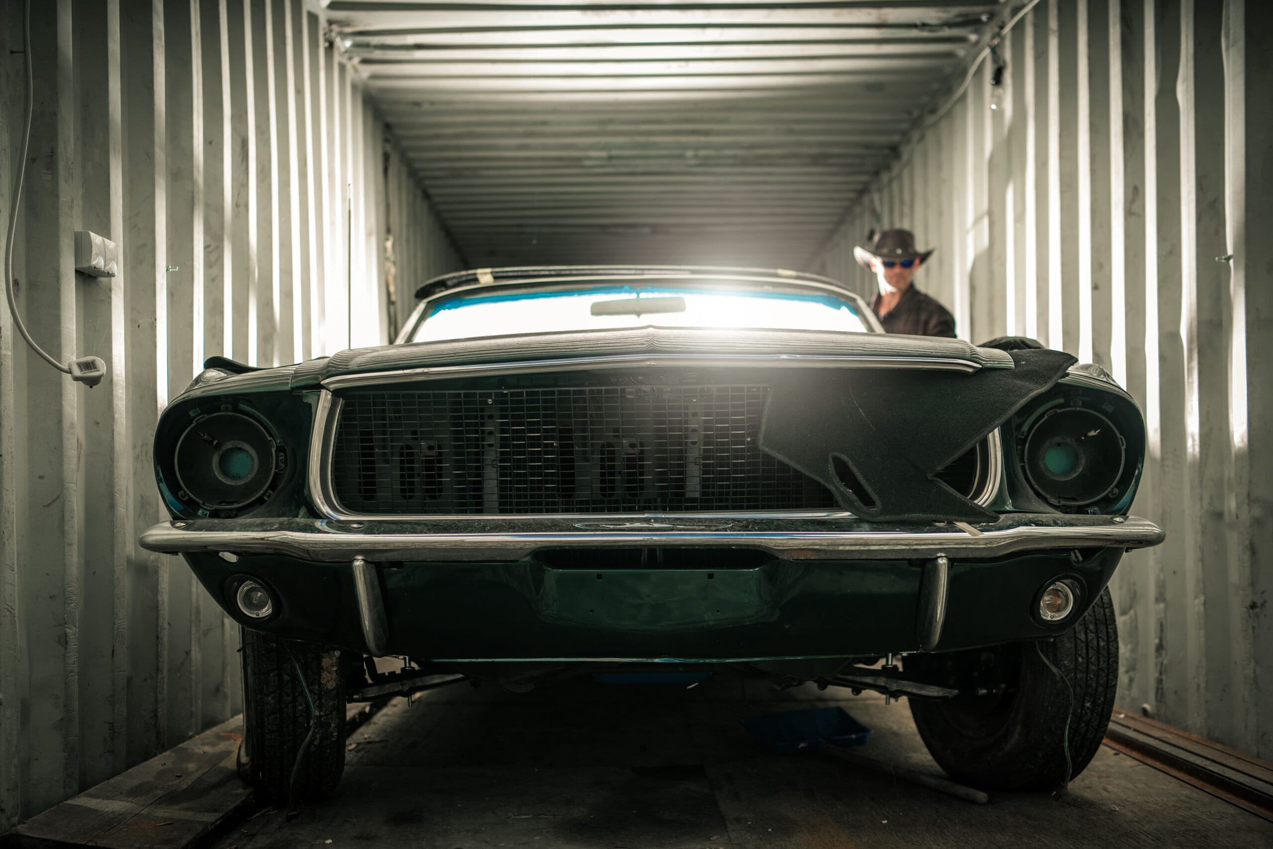 Inside a shipping container garage, car inside being stored